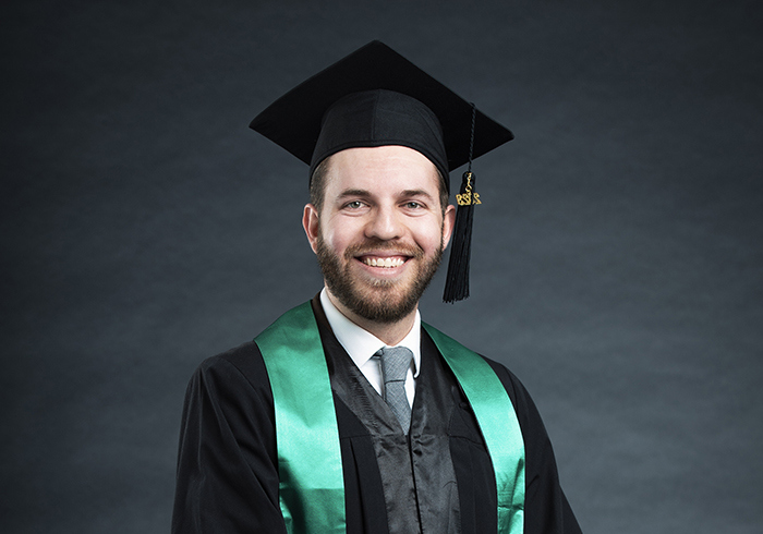 Alumni Mario Vidales in his graduation cap and gown